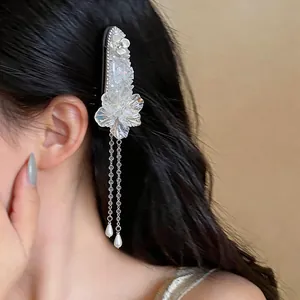 Close-up detail of an elegant French style flower hair clip with pearl tassels on hair