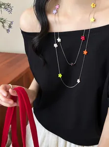 Close-up view of a double-layer necklace featuring vibrant colorful resin flower charms