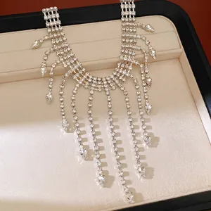 Elegant rhinestone fringe necklace with water-drop charms displayed in a jewelry box