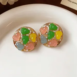 Colorful heart-shaped resin and pearl round stud earrings in an elegant gold finish