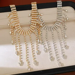 Close-up detail of rhinestone teardrop tassel necklaces in gold and silver finishes