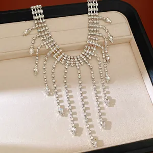 Detailed view of a luxury rhinestone fringe necklace featuring teardrop crystal tassels