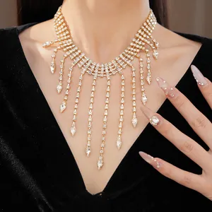 Close-up detail of luxurious gold-toned rhinestone tassel necklace with teardrop pendants