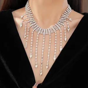 Close-up detail of luxury rhinestone fringe necklace featuring elegant teardrop pendants
