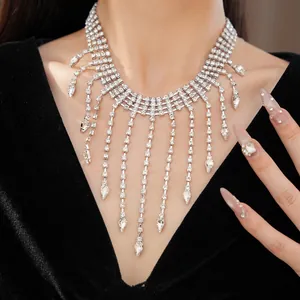 Elegant diamond teardrop tassel necklace close-up on a model wearing black velvet.