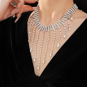 Detailed close-up showing the sparkling rhinestone fringe and teardrop pendants on a choker