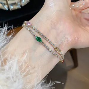 Detailed macro view of elegant 18k gold plated zircon bracelets with colorful stones