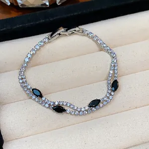 Close-up of 18k gold plated bracelet with sparkling zircons and black marquise stones