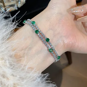 Detailed view of luxury double-layer silver-plated bracelet with sparkling green gemstones