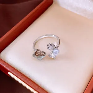 Elegant silver open ring featuring a pearl and zircon, minimalist fashion jewelry for women.