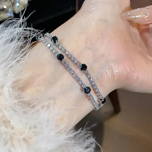 Detailed close-up of a double-layered 18k gold plated zircon bracelet on wrist