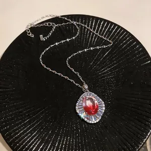 Macro view of vintage court style zircon necklace with sparkling red oval stone