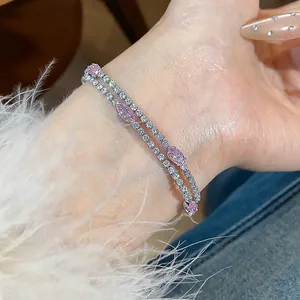 Close-up of elegant silver bracelet with sparkling pink marquise zircons on wrist
