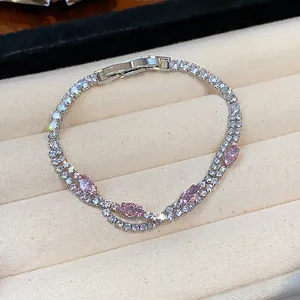Close-up of 18k gold plated tennis bracelet with pink marquise stones in a jewelry box