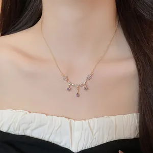 Detailed view of 18k gold plated necklace with purple zircon flower and waterdrop pendants