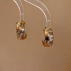 Elegant 18k gold plated honeycomb hoop earrings with CZ stones on clear stands