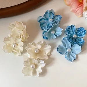 Elegant handmade fabric flower hair clips with pearl centers for beach vacations