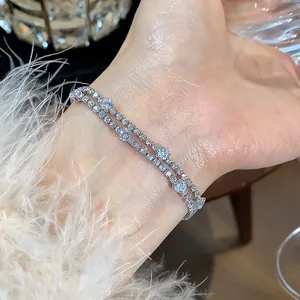 Detailed macro view of a sparkling zirconia double-strand bracelet on a model's wrist