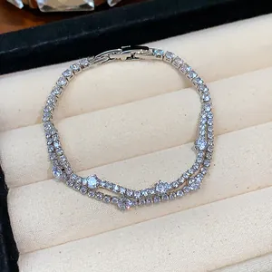 Detailed macro view of an 18k gold plated double-layer zircon bracelet in a box