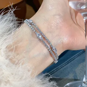 Detailed view of luxury 18k gold plated bracelets with marquise cubic zirconia.
