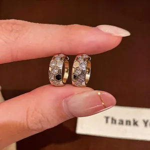 Close-up detail of 18k gold plated honeycomb hoop earrings with sparkling zircon stones
