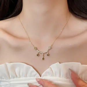 Macro view of 18k gold plated zircon flower necklace featuring elegant green gemstone accents.