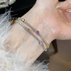 Macro view of luxurious 18k gold plated bracelets featuring sparkling colorful zircon stones