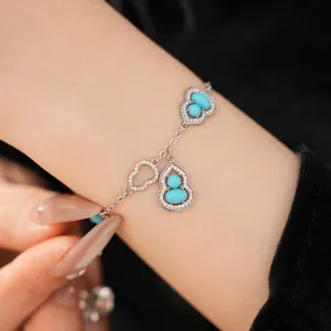 Close-up of 18K gold plated Wulu bracelet with turquoise-blue stones and zircons.