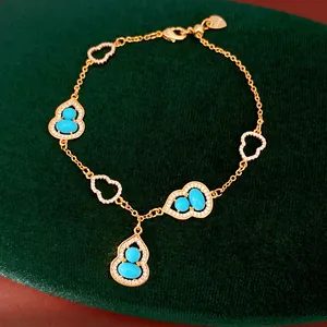 Close-up of exquisite 18K gold plated Wulu gourd bracelet with turquoise stones and zircon accents