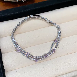Detailed close-up of double-layer zircon bracelet with pink stones on beige velvet