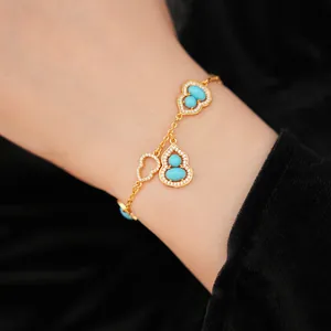 Detailed view of 18K gold plated bracelet featuring turquoise calabash and zircon accents