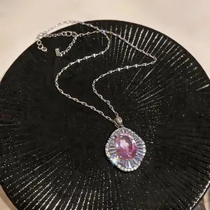Close-up of vintage palace style necklace with pink gemstone and zircon accents