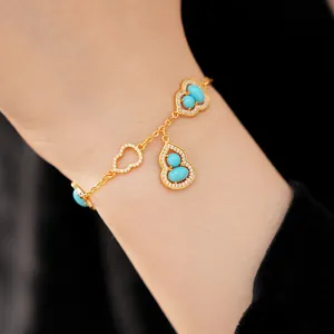 Detailed view of 18K gold plated gourd charm bracelet with turquoise and zircon stones