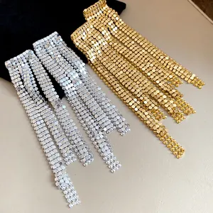 Close-up detail of shimmering silver and gold mesh tassel earrings for fashion jewelry