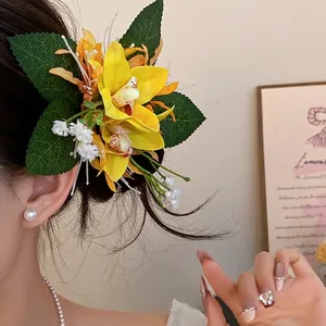 Elegant yellow fabric floral hair clip accessory worn by a model in a lifestyle setting