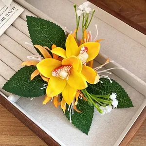 Elegant yellow fabric orchid flower hair clip with delicate green leaves and white buds