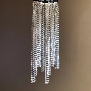 Detailed view of glamorous silver sequin mesh asymmetric tassel earrings for parties