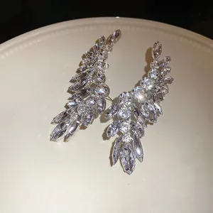 Close-up detail of sparkling leaf-shaped earrings with premium marquise-cut rhinestones