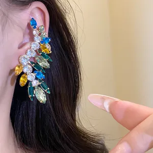 Detailed view of elegant gold-toned ear cuff featuring colorful marquise and round rhinestones