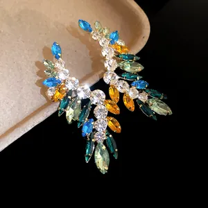 Exquisite close-up of colorful marquise crystal drop earrings on a professional black background