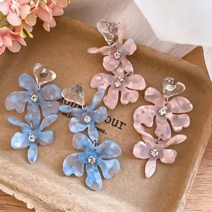 Sweet acetate floral dangle earrings with rhinestones for summer vacation style.