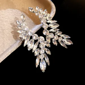 Detail macro view of sparkling marquise and round cut crystal earrings with silver needles.