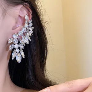 Detailed view of elegant silver-toned rhinestone ear cuff jewelry worn on model's ear