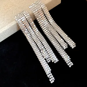Detailed macro view of silver-toned metallic mesh tassel earrings with shimmering texture