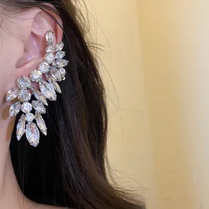 Detailed view of silver needle marquise and round diamond-encrusted ear crawler