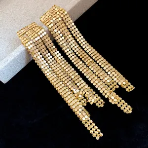 Close-up detail of luxury golden mesh tassel earrings with elegant fringe design