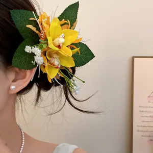 Detailed close-up of a sweet yellow fabric flower hair clip worn on a side bun hair.