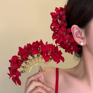 Detailed macro view of red fabric flower hair fork with realistic dewdrop effect