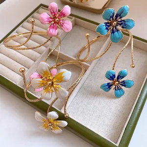 Elegant floral dripping oil metal arm bracelets for women displayed in a jewelry box