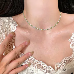 Fresh green and white glass beaded necklace jewelry set worn by a stylish fashion model